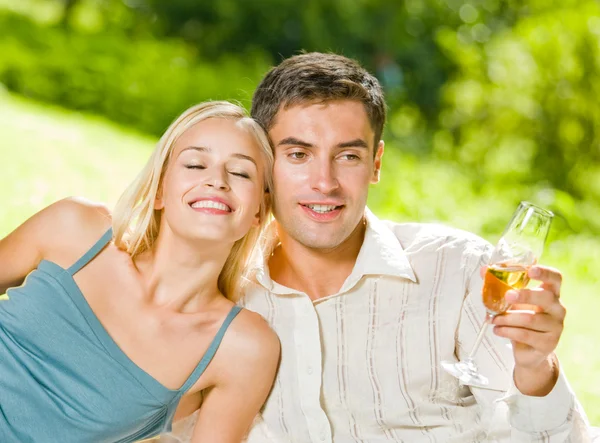 Young happy couple with champagne, outdoor Royalty Free Stock Images