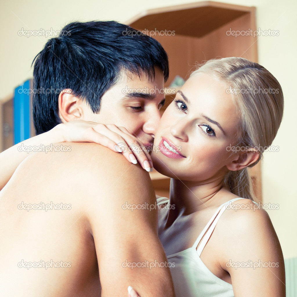 Young embracing cheerful couple