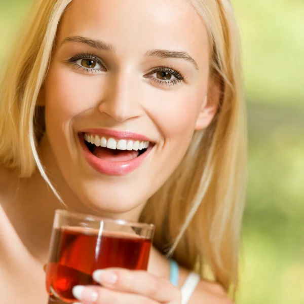 Happy woman drinking juice — Stock Photo, Image