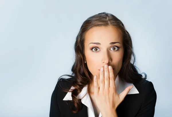 Business woman covering mouth, over blue — Stock Photo, Image