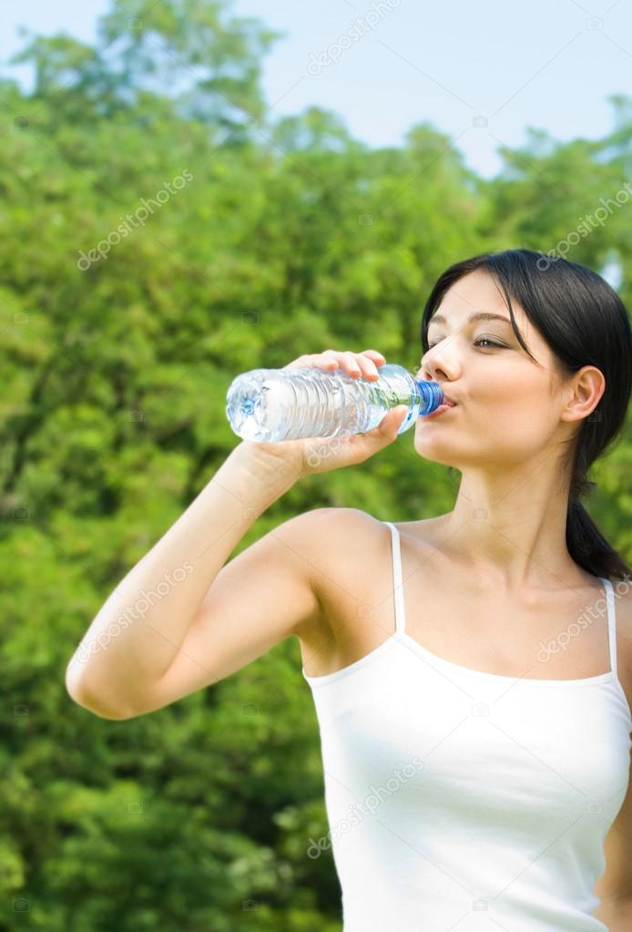 Portrait of woman drinking water outdoor