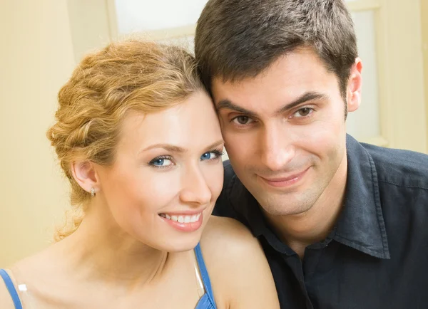 Cheerful smiling young couple, indoors — Stock Photo, Image