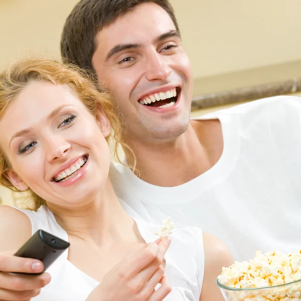 Alegre jovem casal assistindo TV juntos — Fotografia de Stock