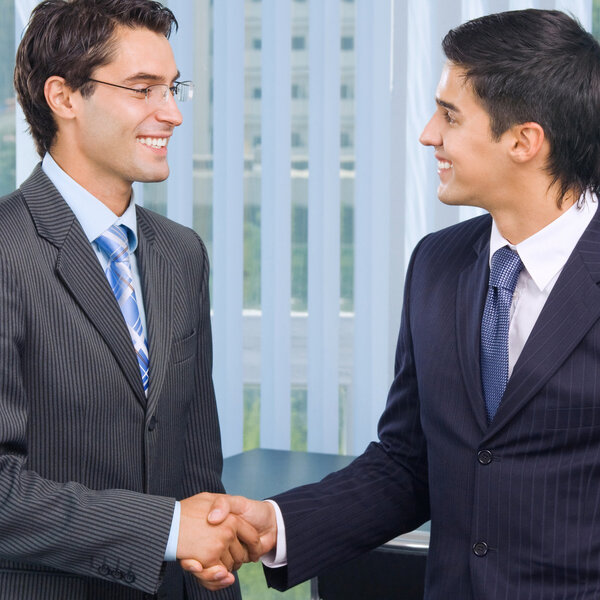 Happy businesspeople handshaking