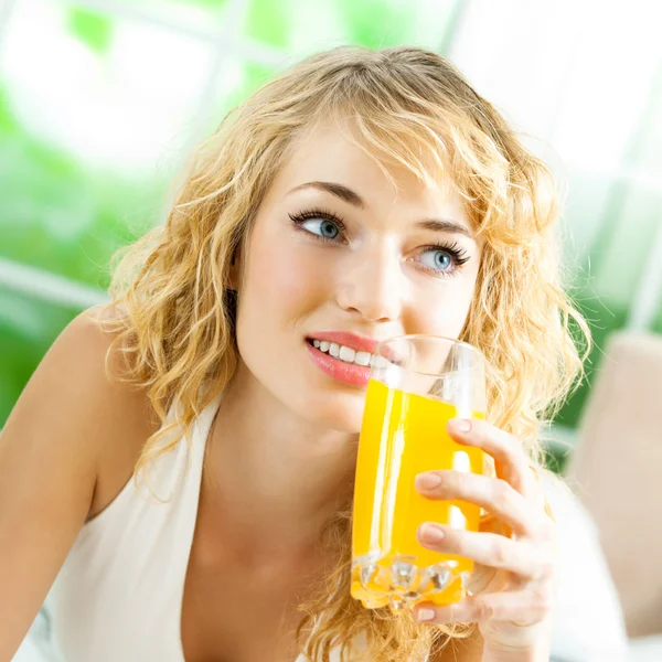 Happy woman drinking juice — Stock Photo, Image