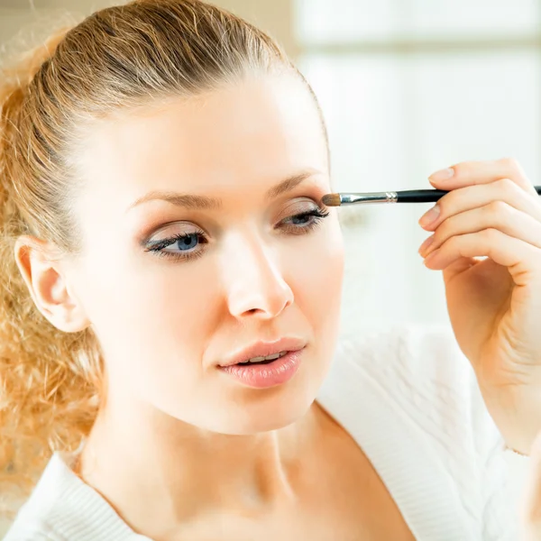 Allegro donna sorridente con specchio e pennello per il trucco — Foto Stock