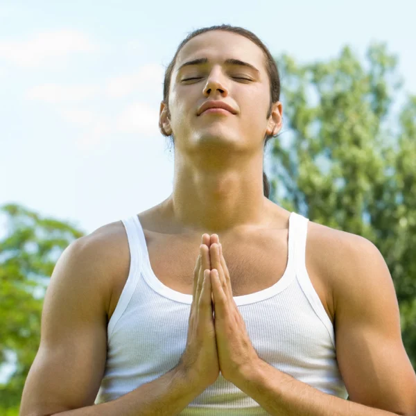 Young man meditating or praying, outdoor — Stock Photo, Image