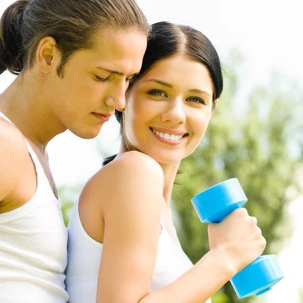 Cheerful couple with dumbbells on workout Royalty Free Stock Photos