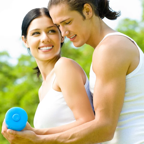 Cheerful couple with dumbbells on workout Stock Image
