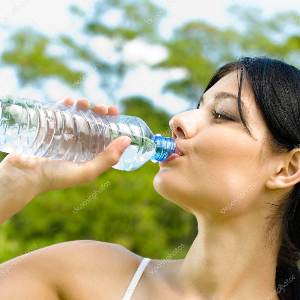 Portrait of woman drinking water outdoor