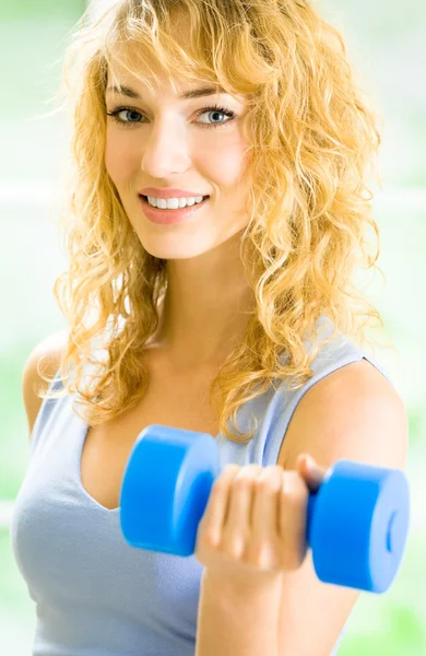 Young happy smiling woman with dumbbells, indoors — Stock Photo, Image