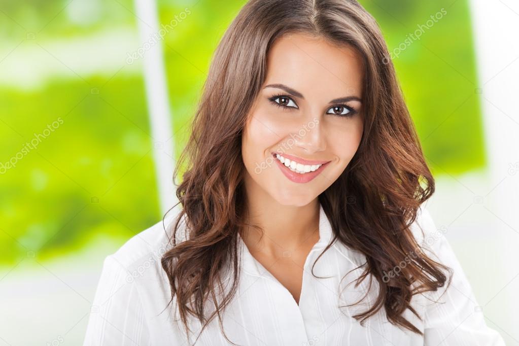 Young smiling cheerful businesswoman at office