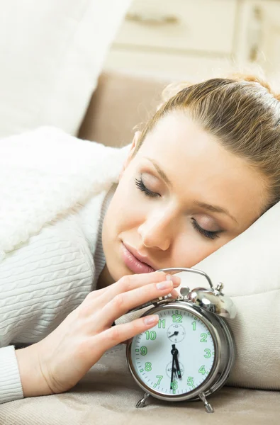 Woman with alarmclock on the bed — Stock Photo, Image