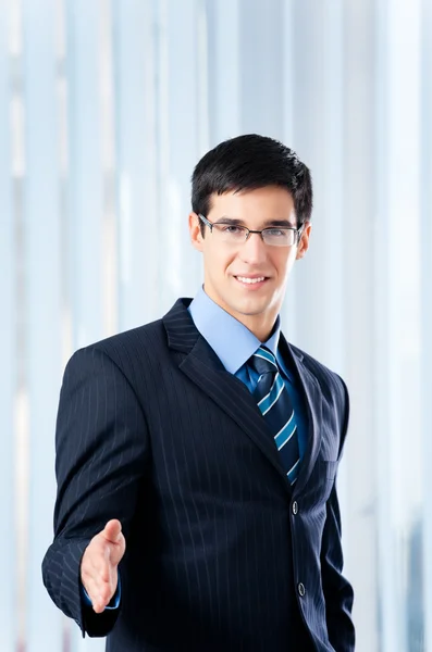 Young businessman giving hand for handshake — Stock Photo, Image