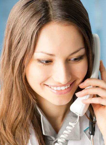 Young doctor on phone, at office — Stock Photo, Image