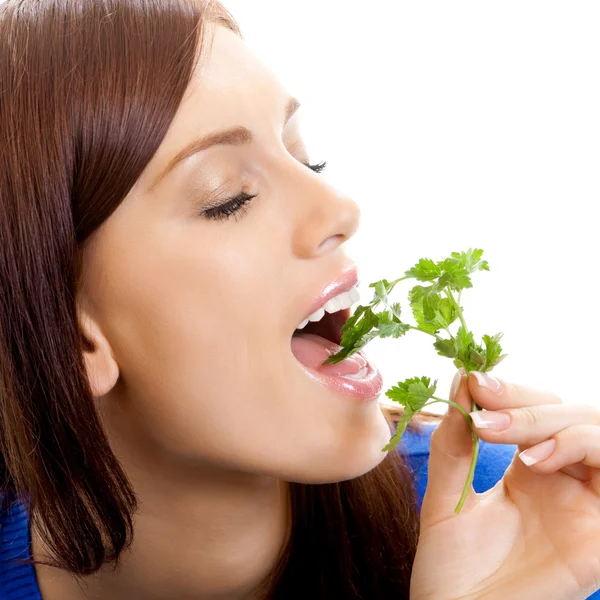 Vrolijke vrouw eten potherbs, over Wit — Stockfoto