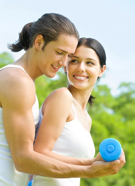 Cheerful couple with dumbbells on workout Royalty Free Stock Images