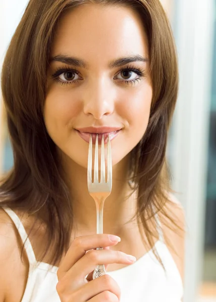 Portrait of young woman with plug, at home — Stock Photo, Image