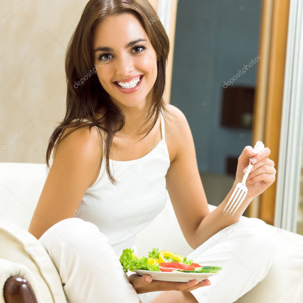 Young woman with salad, at home