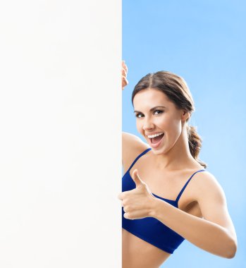 Woman in fitnesswear showing signboard, over blue clipart