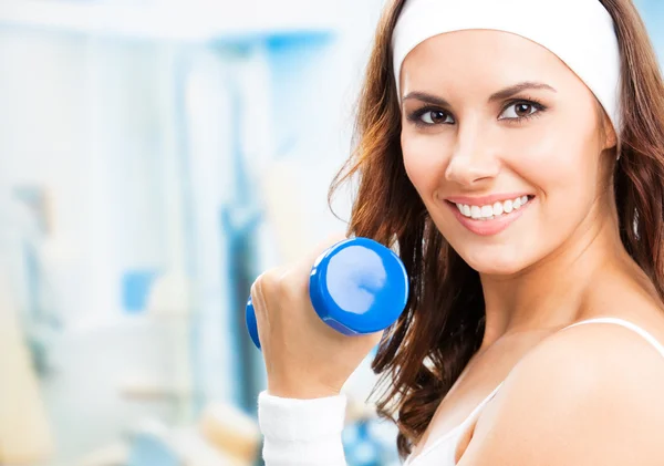 Mujer haciendo ejercicio con la mancuerna, en el gimnasio — Foto de Stock