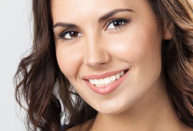 üzerinde gri mutlu gülümseyen genç kadın