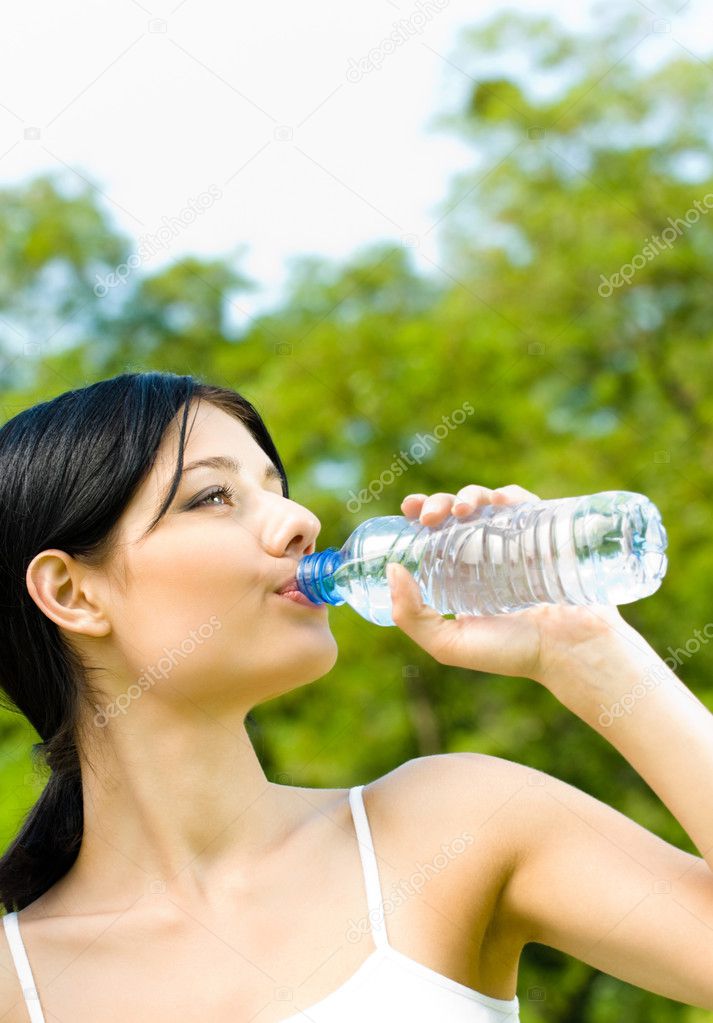 Portrait of woman drinking water outdoor