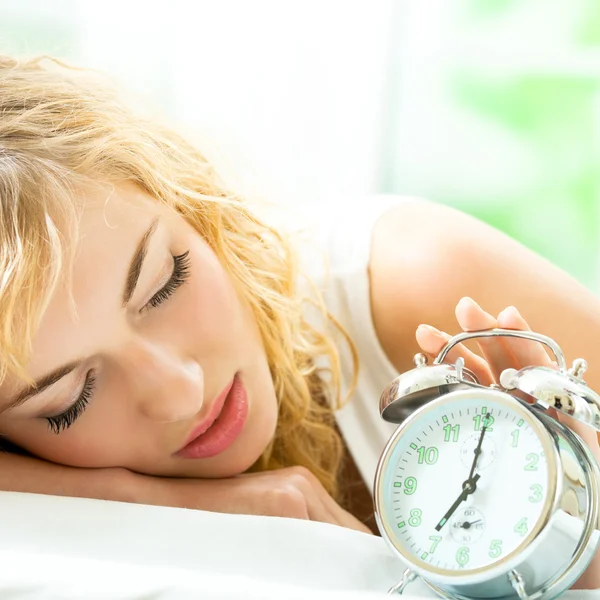 Blond beautiful woman with alarmclock — Stock Photo, Image