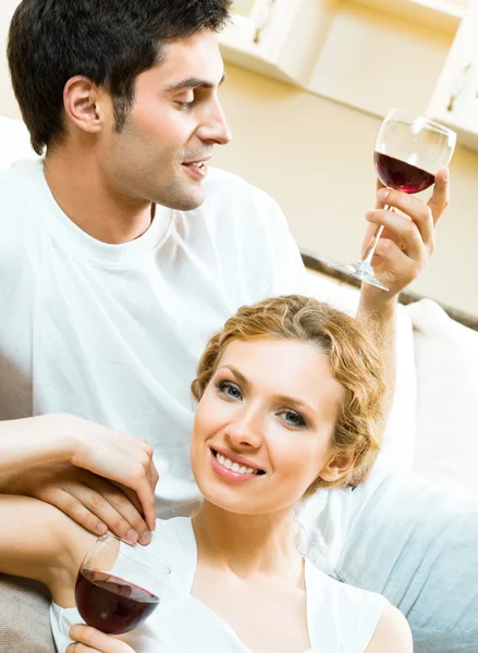 Cheerful couple with glasses of redwine — Stock Photo, Image