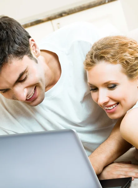 Casal alegre com laptop, em casa — Fotografia de Stock