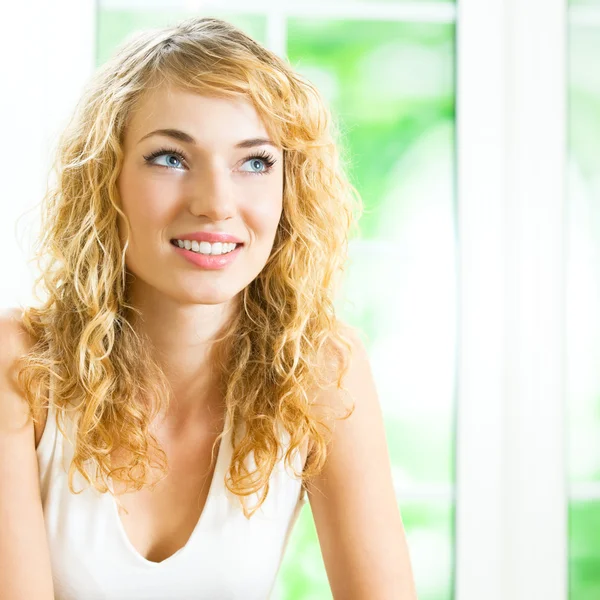 Smiling young beautiful woman, indoors Stock Image