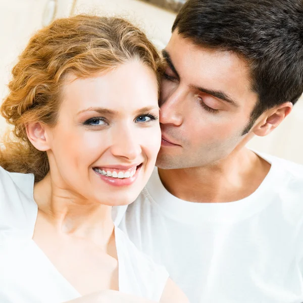 Cheerful smiling young couple, indoors Royalty Free Stock Photos