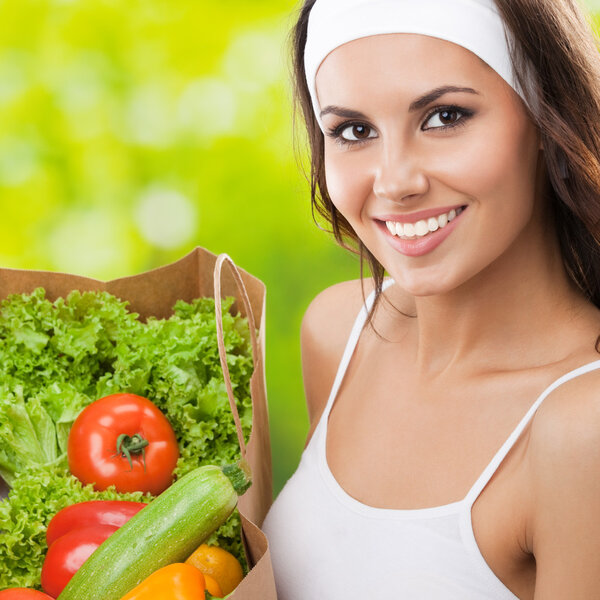 Woman in fitness wear with vegetarian food