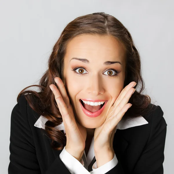 Surprised businesswoman, on gray — Stock Photo, Image