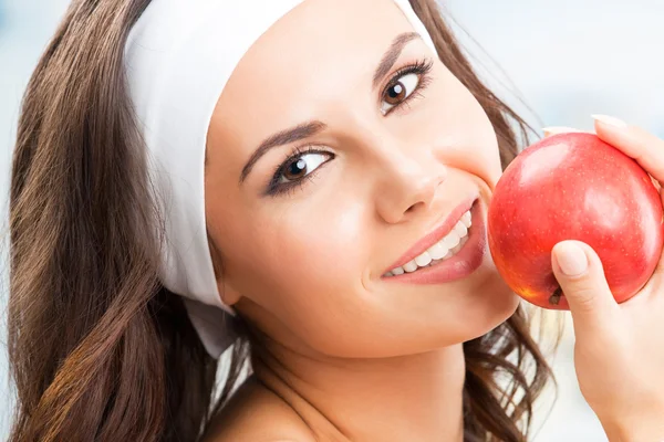 Woman with apple, at fitness center — Stock Photo, Image