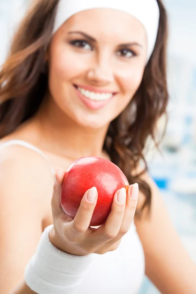 Woman with apple, at fitness center — Stock Photo, Image