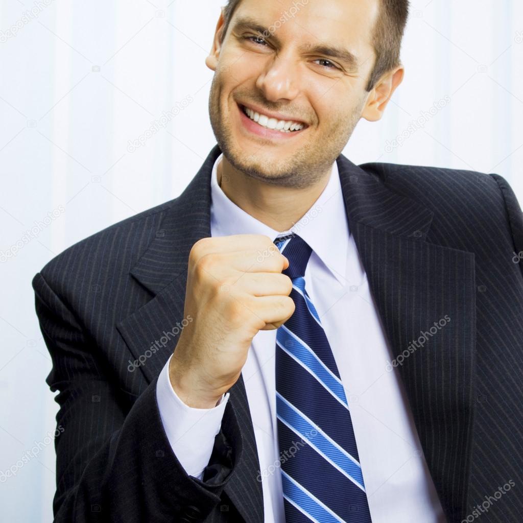 Happy successful gesturing businessman