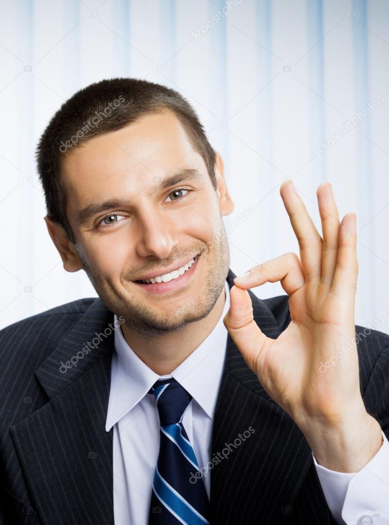 Businessman with okay hand sign at office