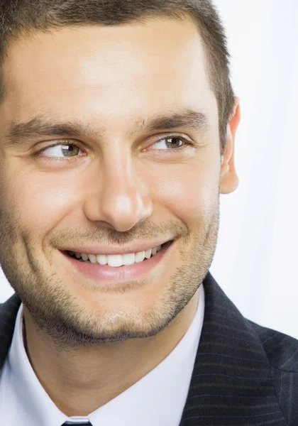 Happy smiling young businessman at office — Stock Photo, Image