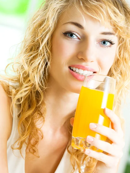 Happy woman drinking juice — Stock Photo, Image