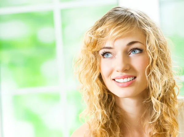 Smiling young beautiful woman, indoors Royalty Free Stock Images