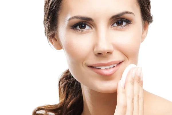 Young woman cleaning skin by cotton pad, over blue — Stock Photo, Image