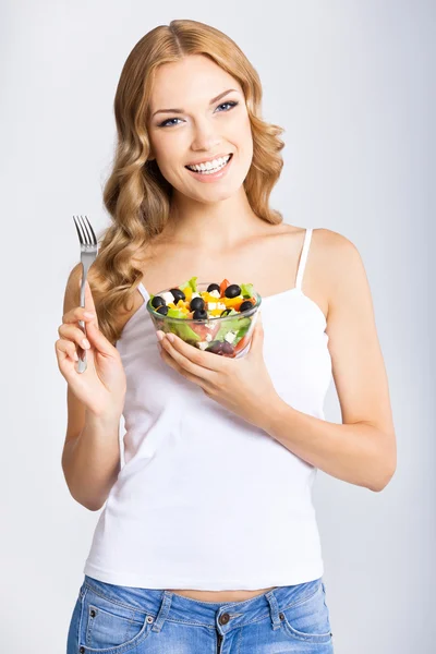 Жінка з вегетаріанським салатом, над сірим — стокове фото