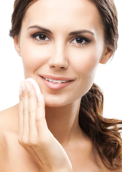 Young woman cleaning skin by cotton pad, over blue — Stock Photo, Image