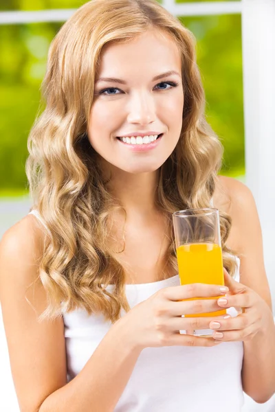 Happy woman drinking juice Stock Image