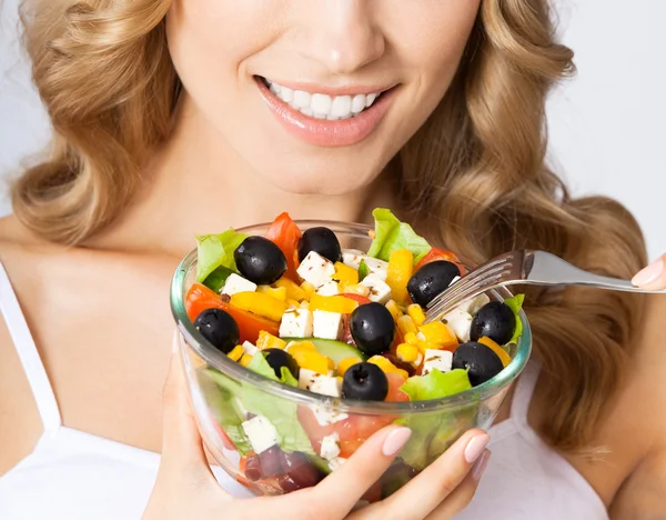 Kvinna med vegetarisk sallad, över grå — Stockfoto