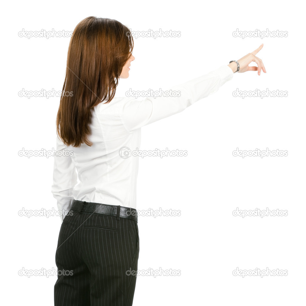 Young business woman pointing at something in her back, isolated