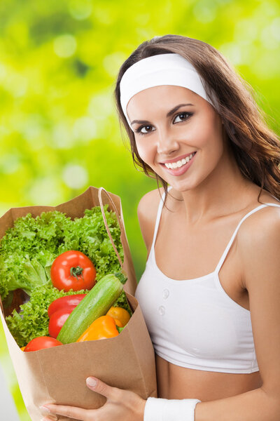 Woman in fitness wear with vegetarian food