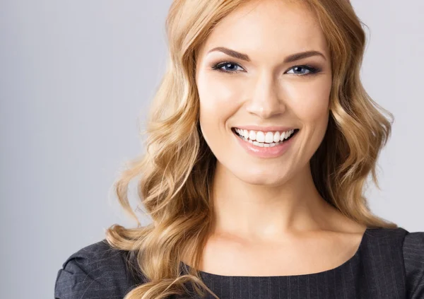 Young cheerful business woman, on gray — Stock Photo, Image