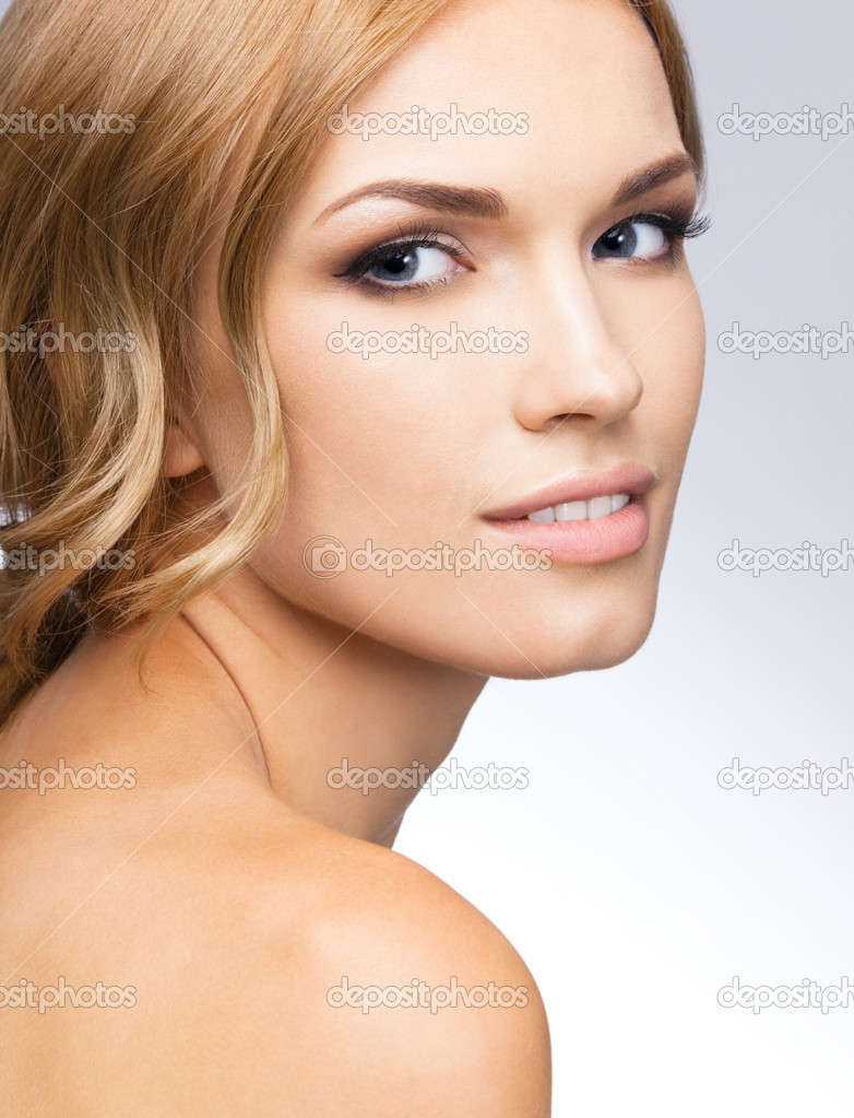 Portrait of beautiful woman, over grey